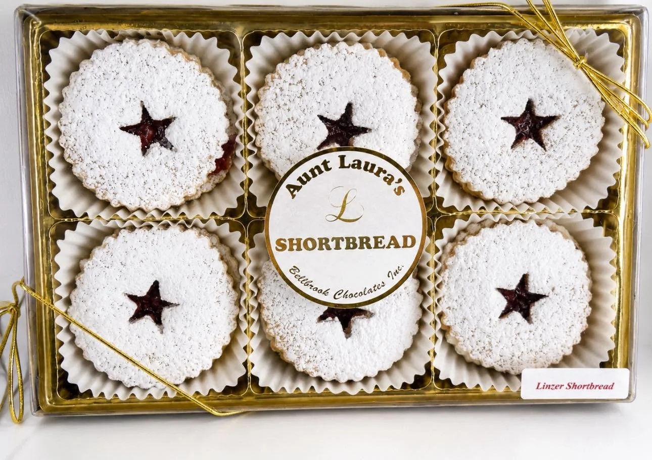 Aunt Laura&rsquo;s Linzer Shortbread Cookies are a customer favorite for a reason. 

Buttery, melt-in-your-mouth shortbread cookies filled with sweet raspberry preserves and finished with a generous dusting of powdered sugar. Every bite is the perfec
