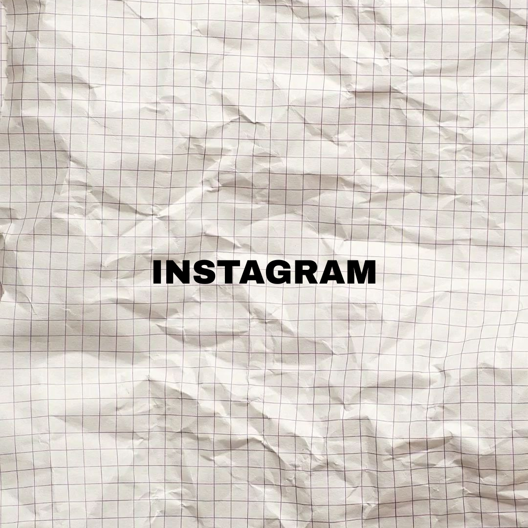 Crumpled sheet of graph paper with the word 'INSTAGRAM' written in bold black letters in the center.
