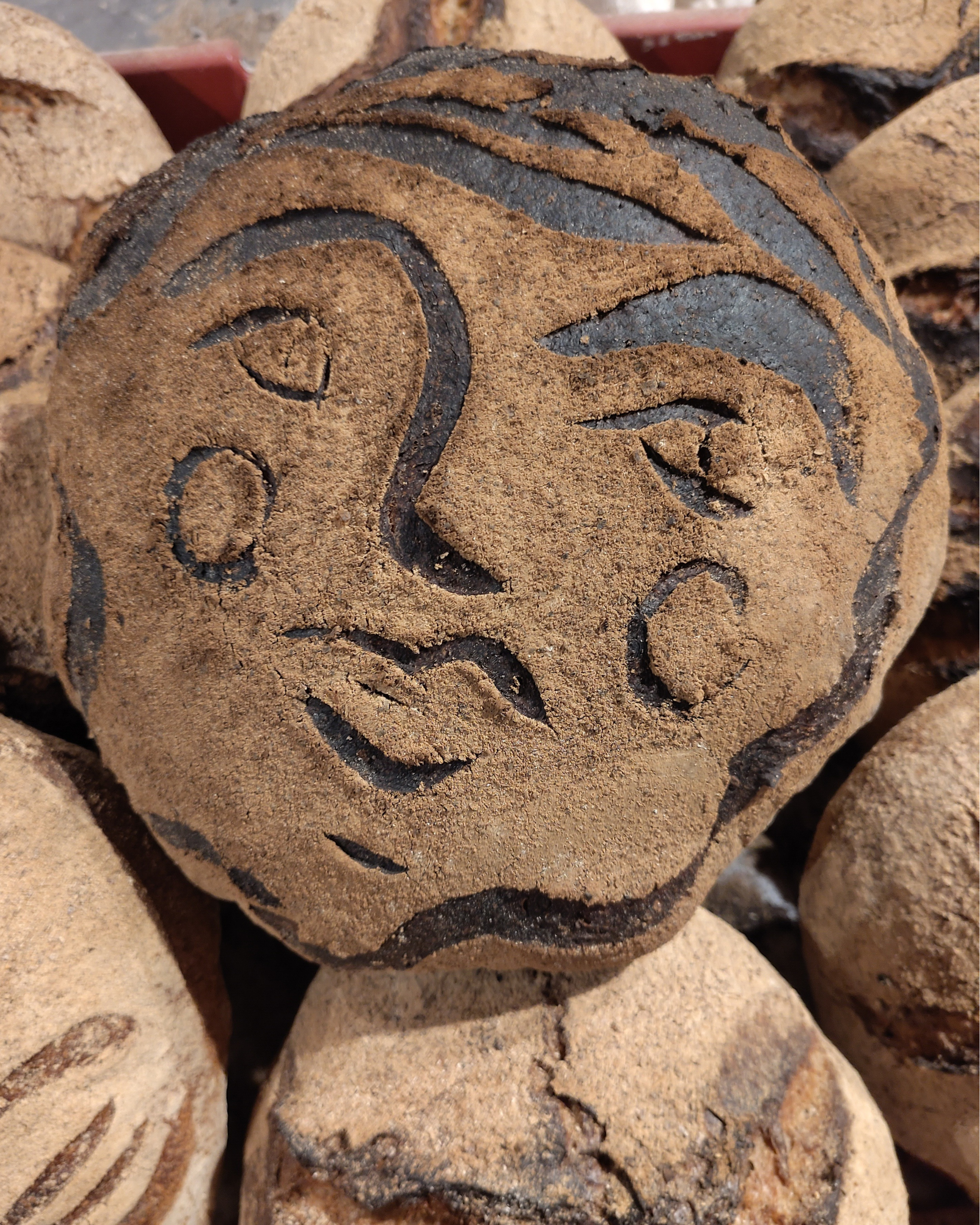 Close-up of several cinnamon sticks with a detailed, textured surface, highlighting the brown color and rolled shape.