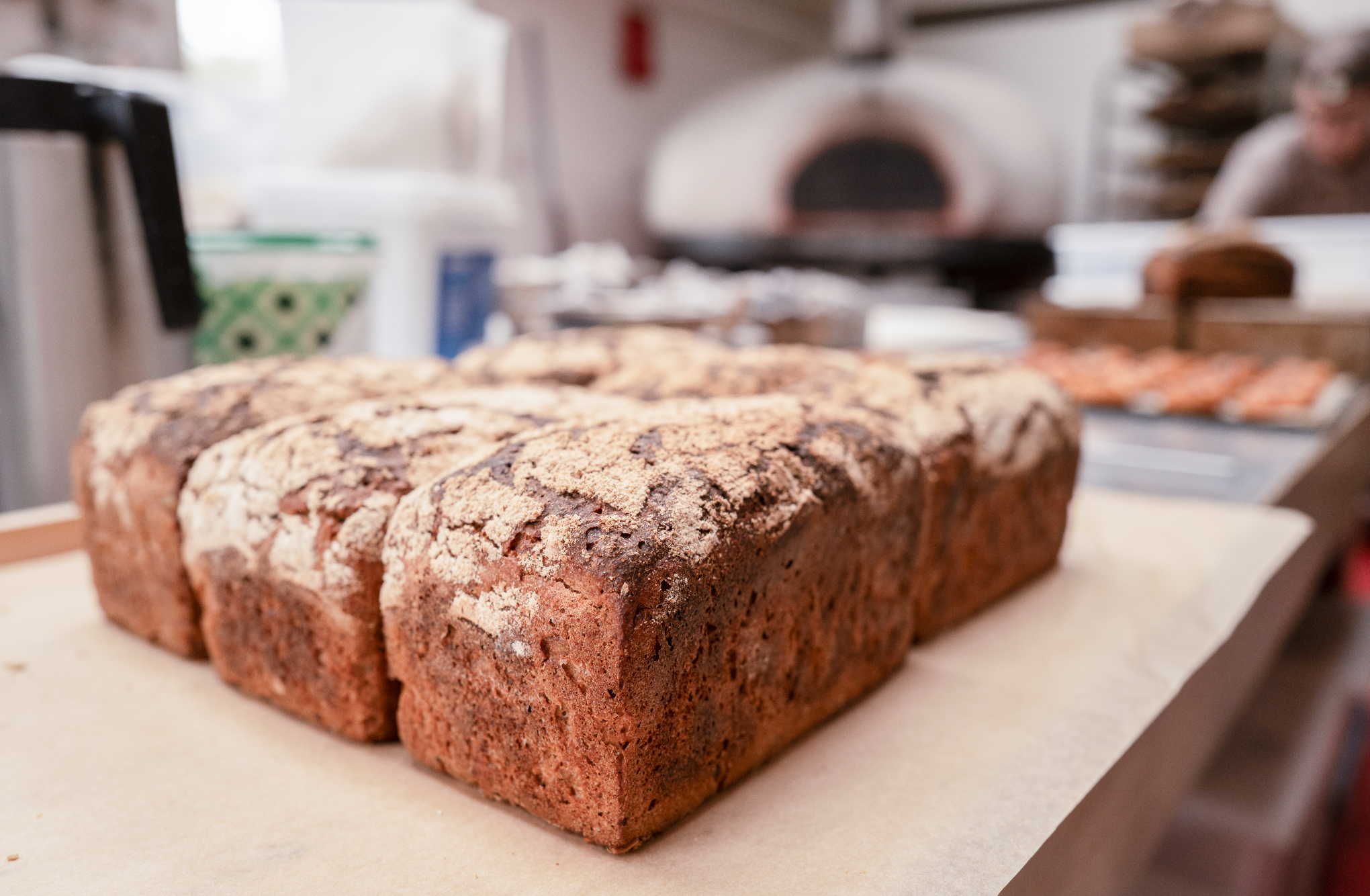 Freshly baked bread loaf with a crusty top on a kitchen counter.