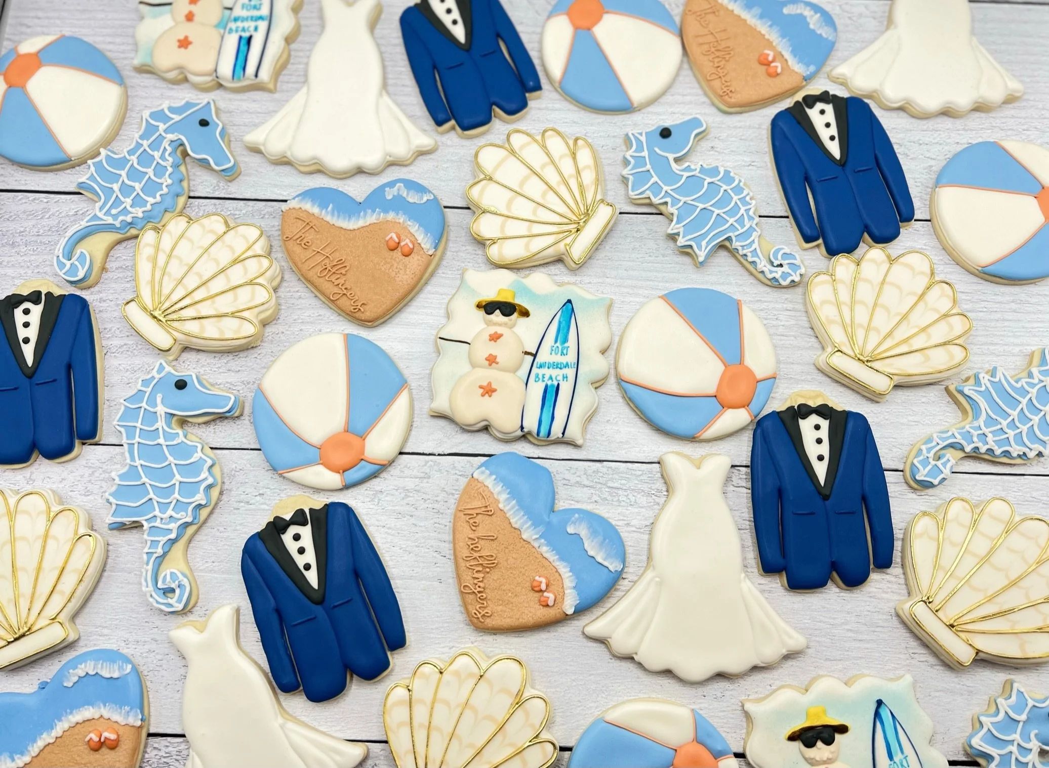 A series of custom cookies to celebrate a beach themed wedding