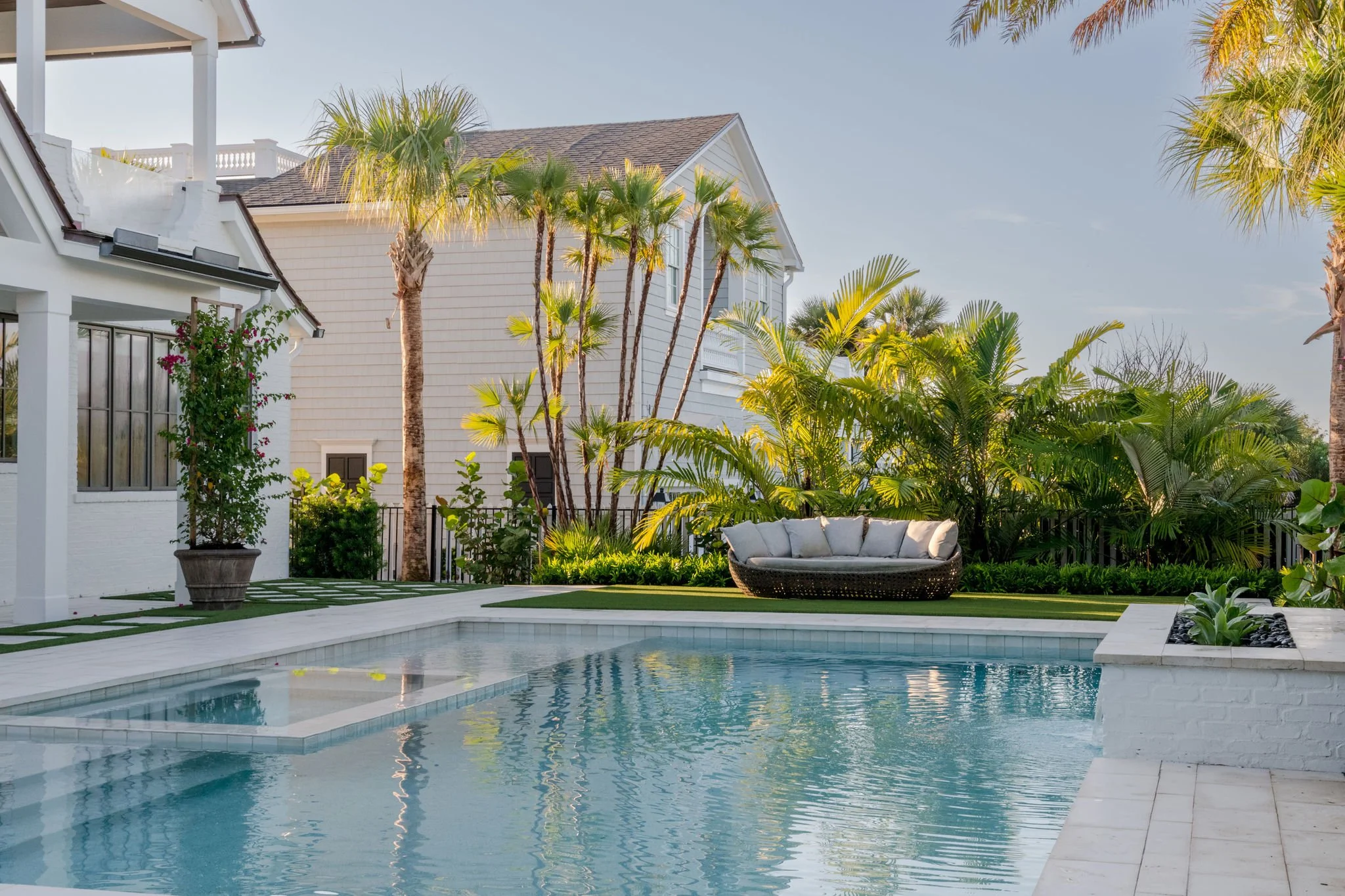 Luxury coastal pool surrounded by layered tropical palms and lush landscaping at Bellecôte in Ponte Vedra Beach, Florida.