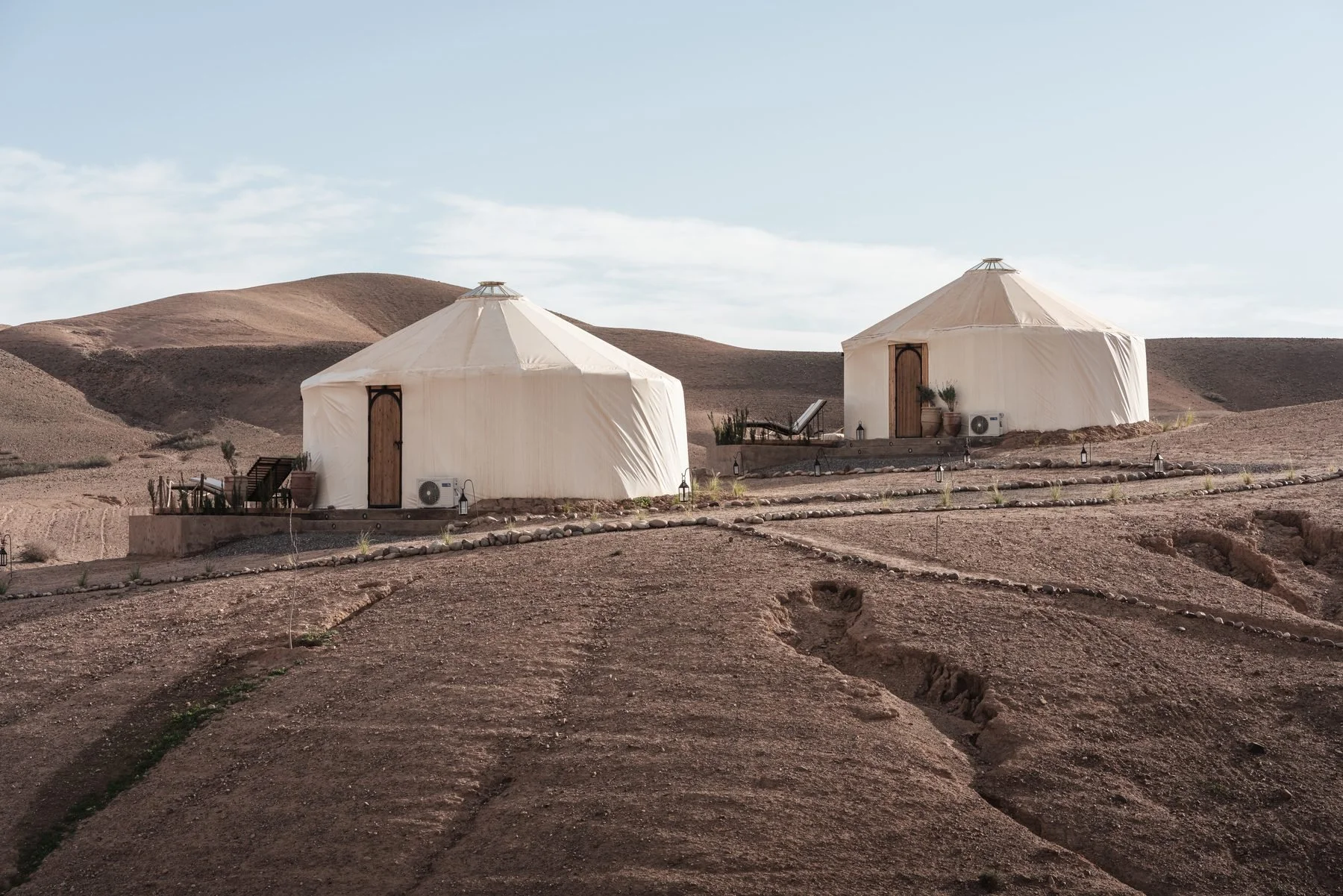 Yurts and private terraces overlooking Morocco’s Agafay stone desert.