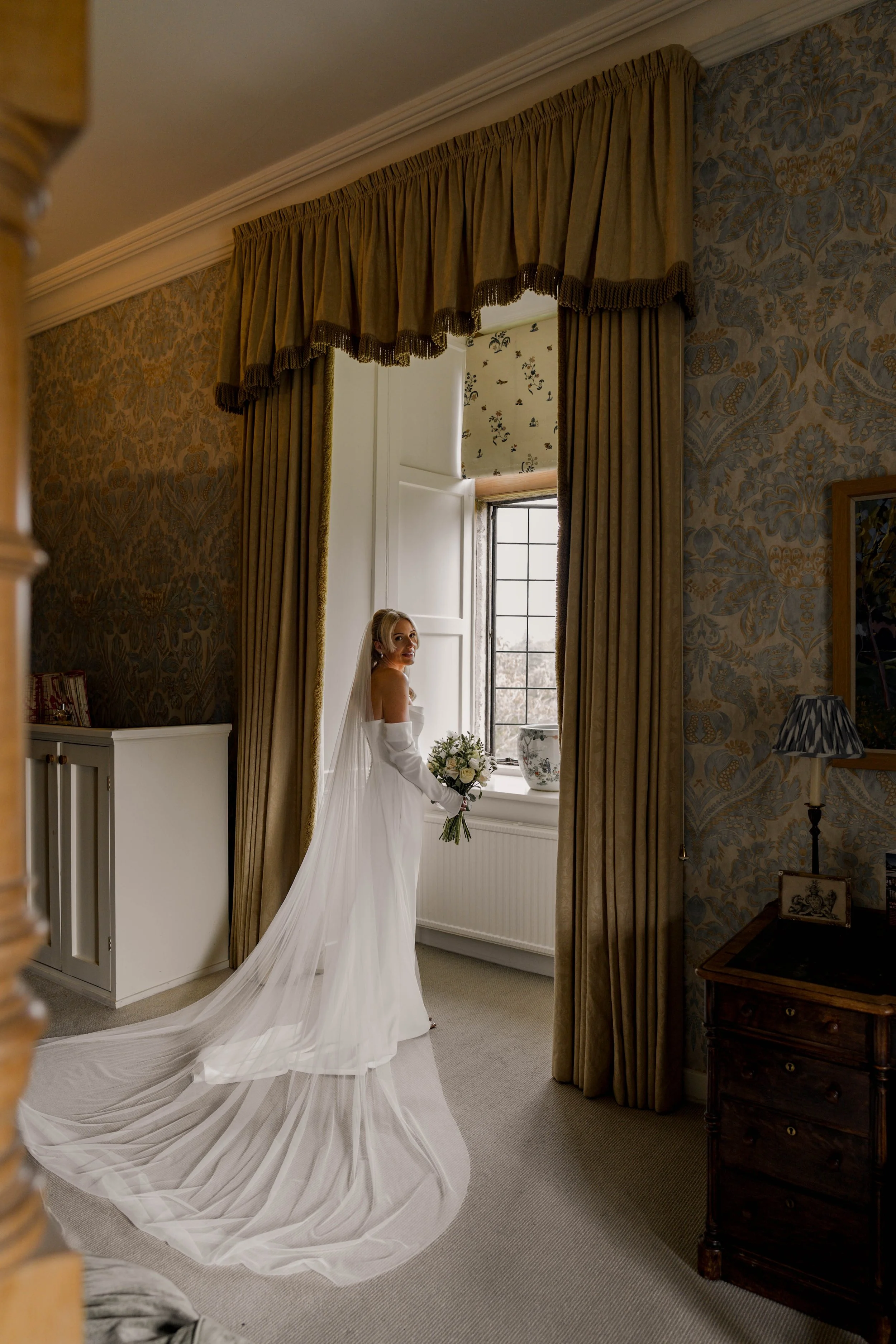 Askham Hall bride, bridal portrait in wedding dress, veil and with bridal bouquet