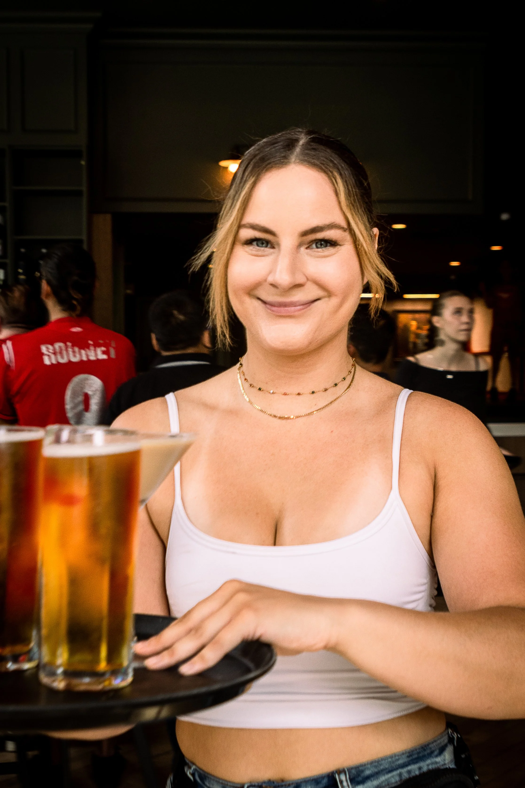Charlie Social House - server carrying tray to guest for bottomless beer experience