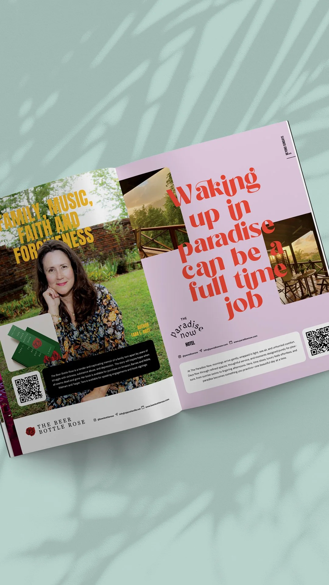 Open magazine showing two pages, one with a woman and text about family, music, faith, and togetherness, the other with an outdoor view and bold red text reading 'Waking up in paradise can be a full time job', with a QR code, on a light green surface with shadow of a plant.