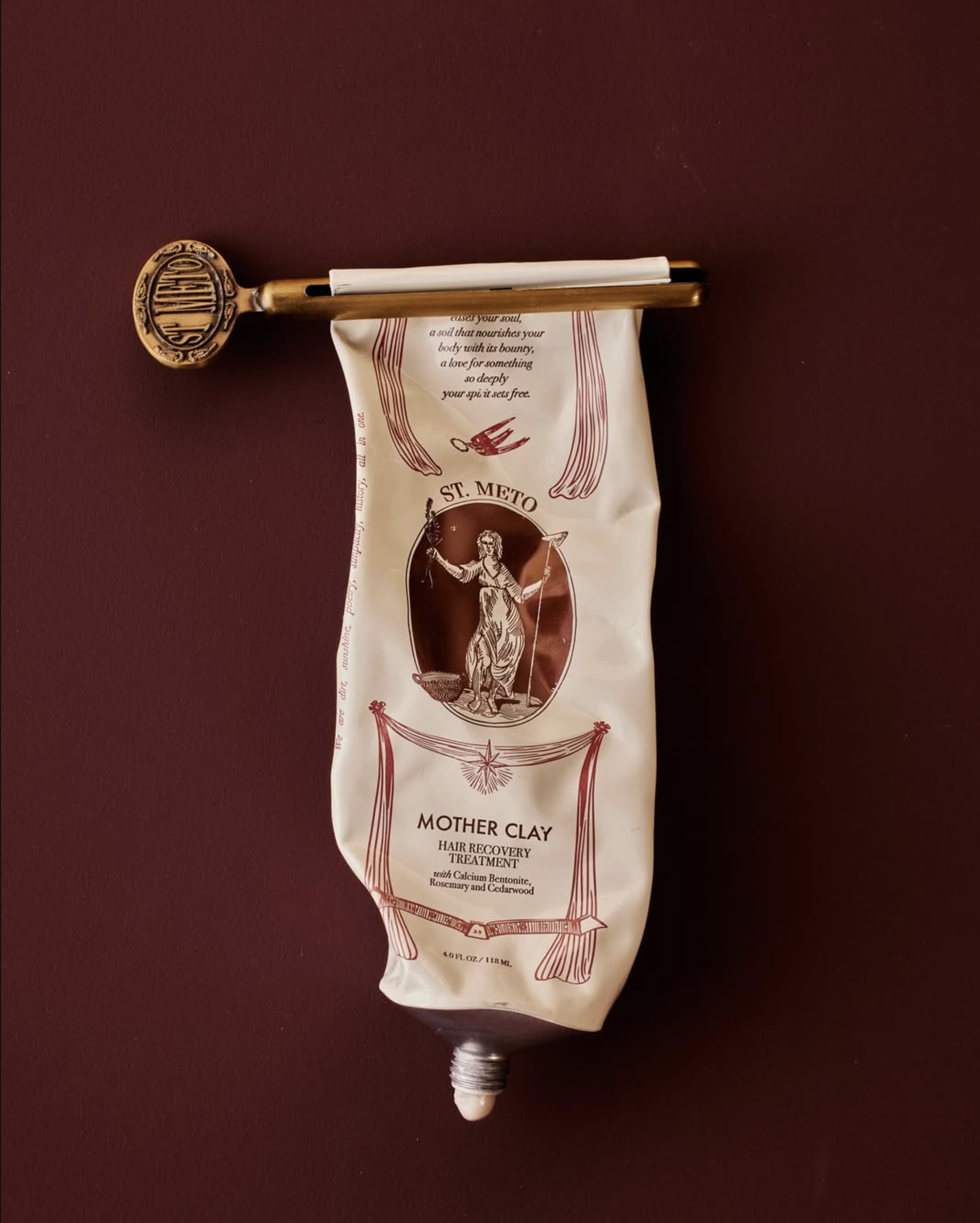 A used tube of hair clay is displayed with the tube key