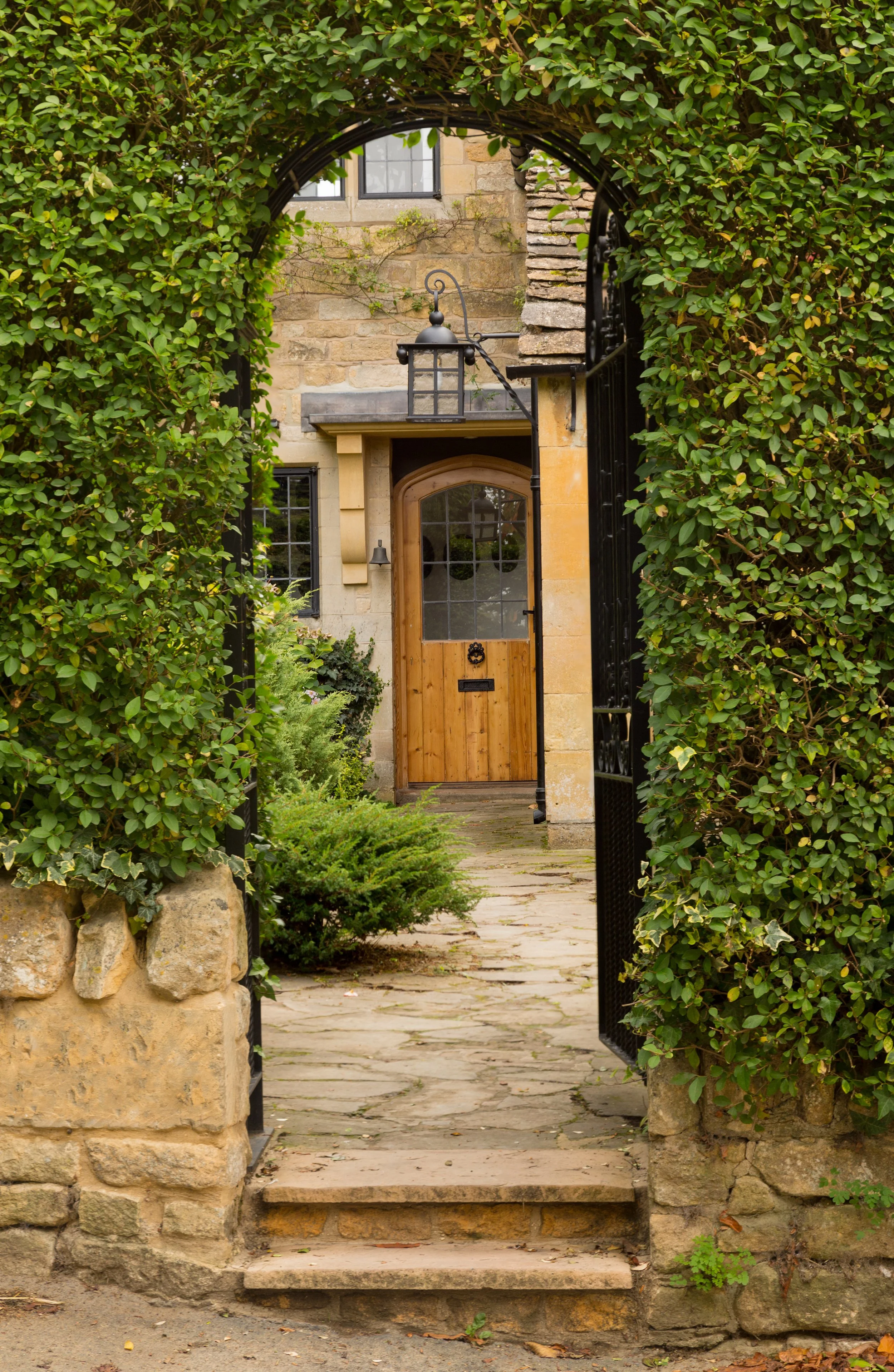 Stone archway and wooden door of a luxury home in Middle Tennessee.