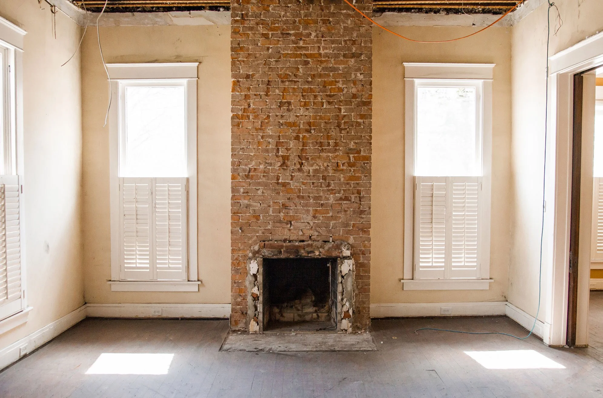 Unfinished living room with brick fireplace. Custom home Nashville renovation project.