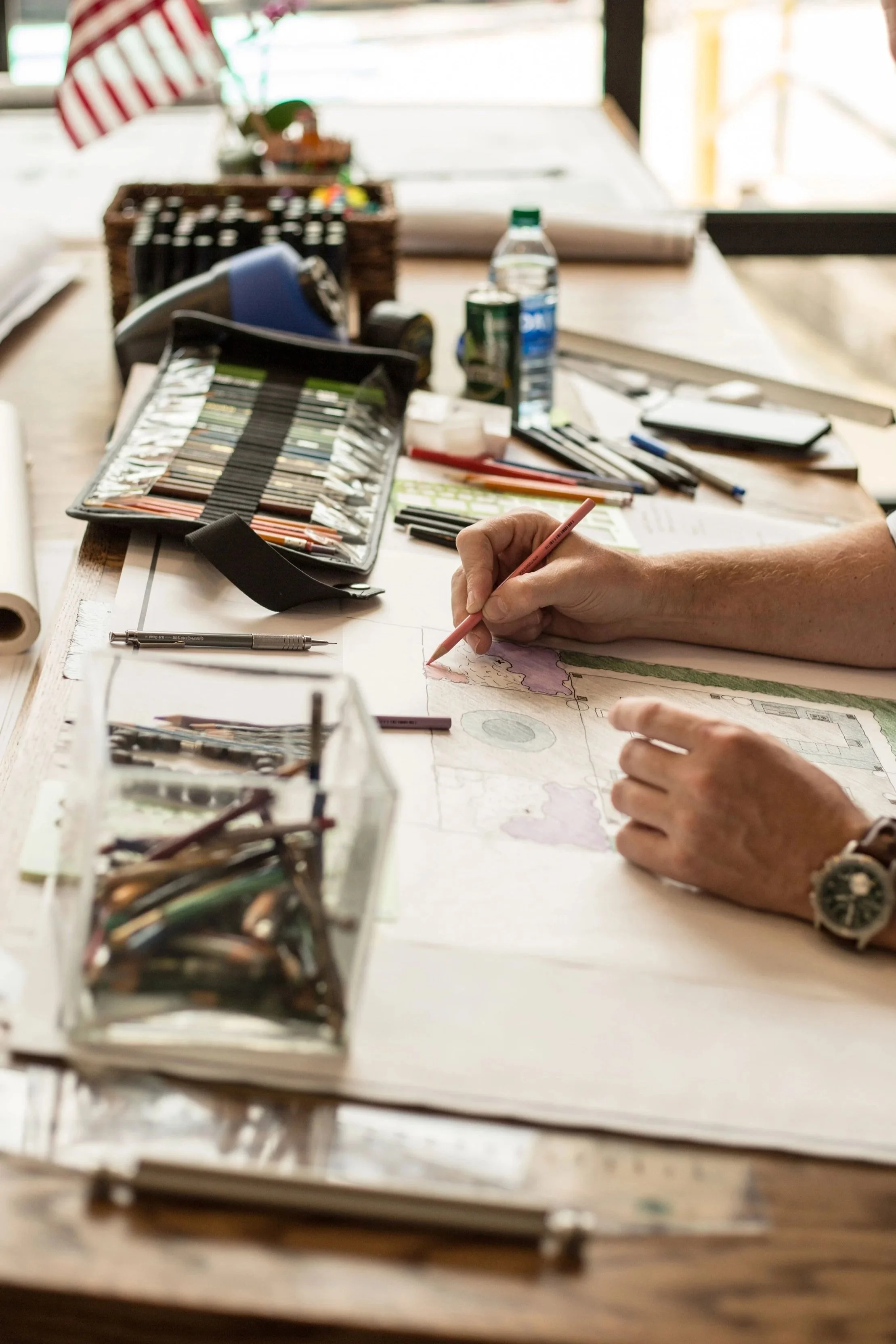 Landscape design drawing by custom home builder Nashville; pencils, plans, American flag.