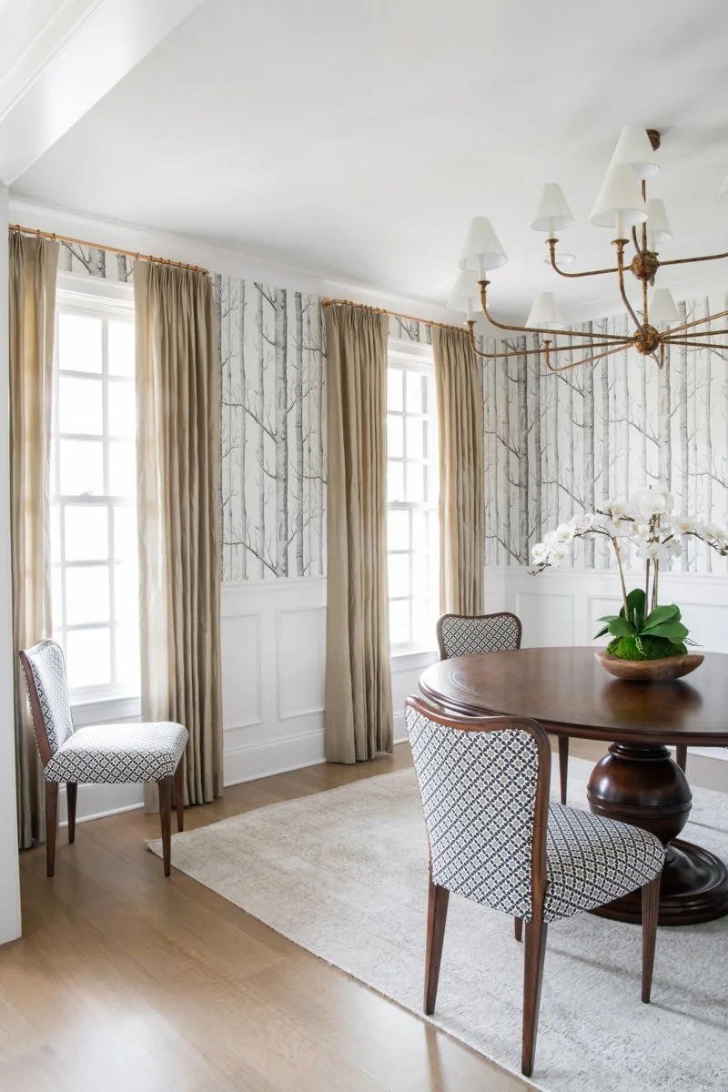 Elegant dining room with birch wallpaper and custom chandelier by luxury home builder Nashville.