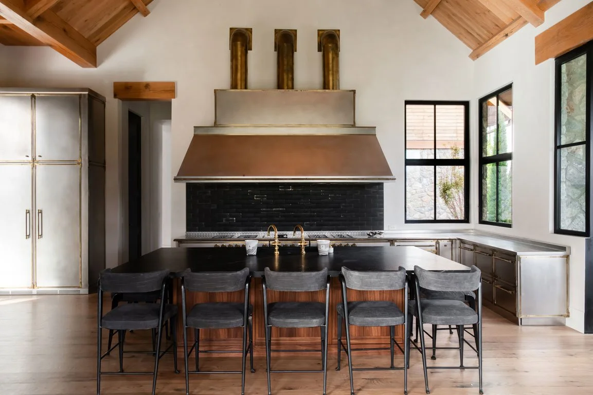 Modern farmhouse kitchen in Nashville custom home. Vaulted wood ceiling, black brick backsplash, island seating.
