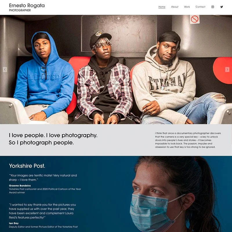 Three men sitting on a bus or train, one in a blue hoodie, one in a black and white plaid jacket and cap, and one in a gray hoodie, with various expressions.