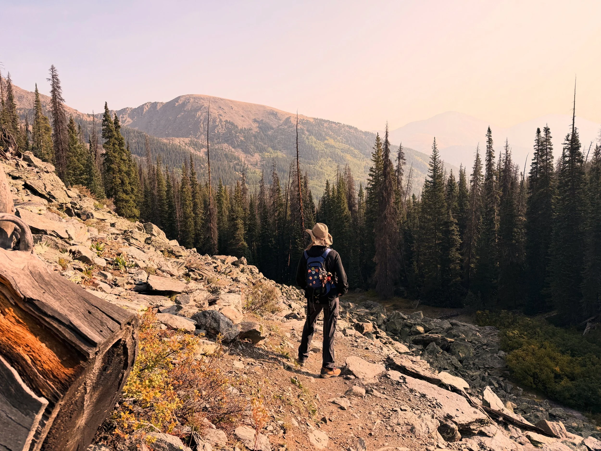 Tati stands on a mountain side