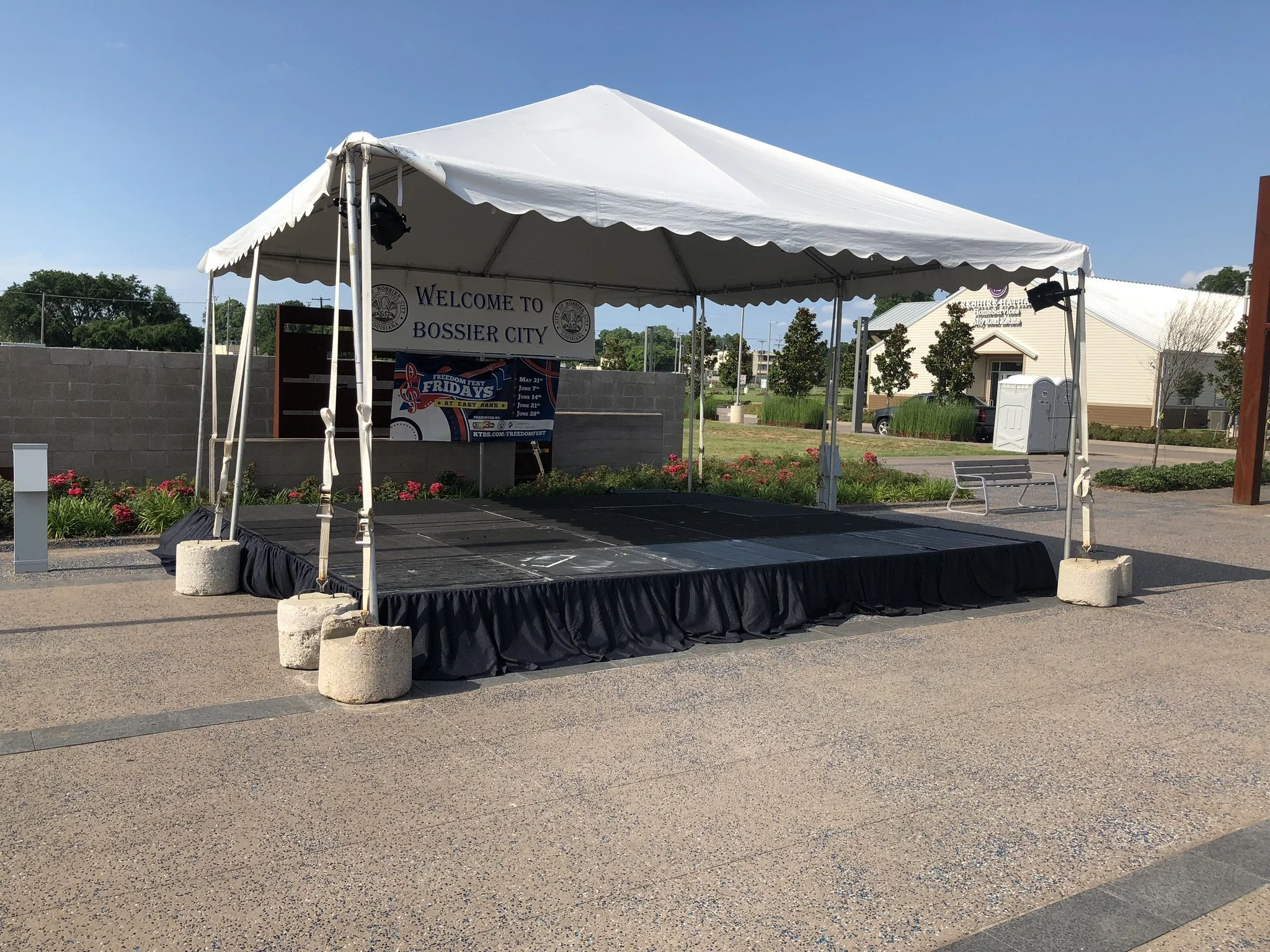Empty outdoor stage with a white canopy tent, 