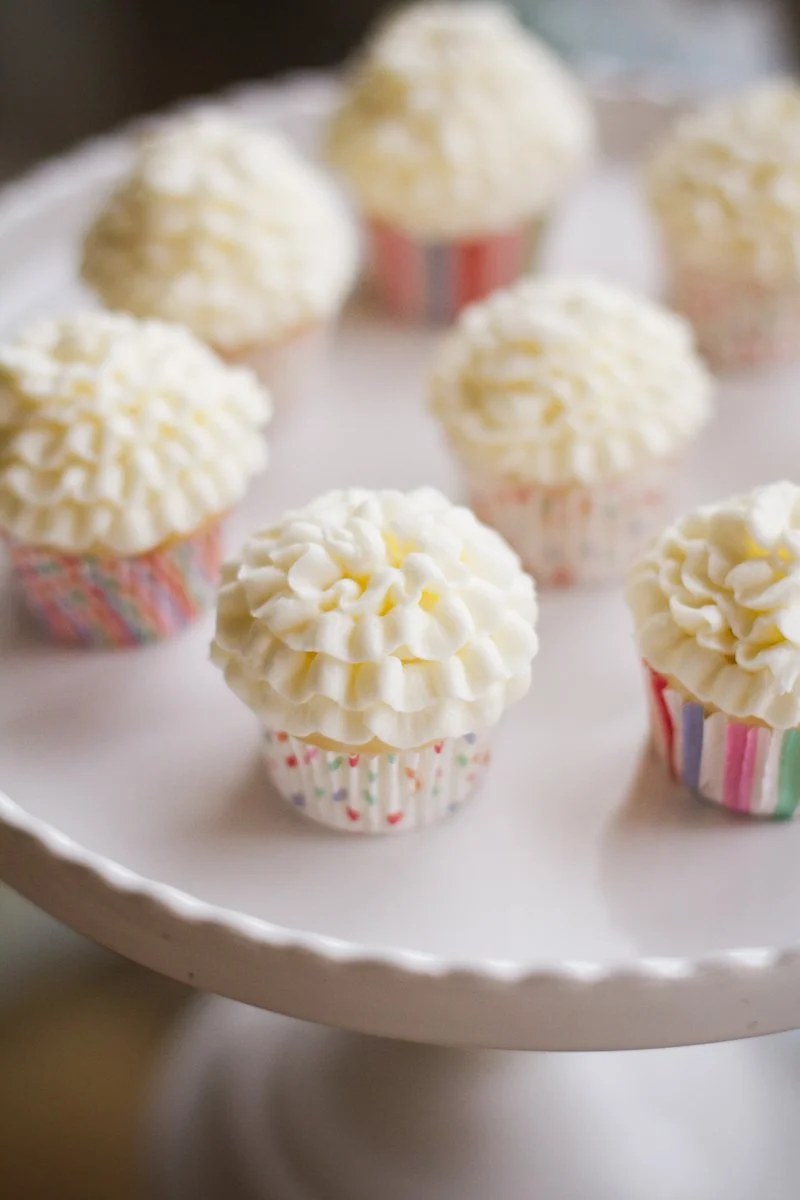 Cupcakes with white frosting and sprinkles on a white cake stand.  Product Photography Chicago IL, Erin Drewitz Photography