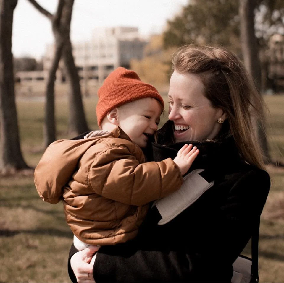 Erin Drewitz Photography About Me Photo holding so outdoors, both smiling and laughing.
