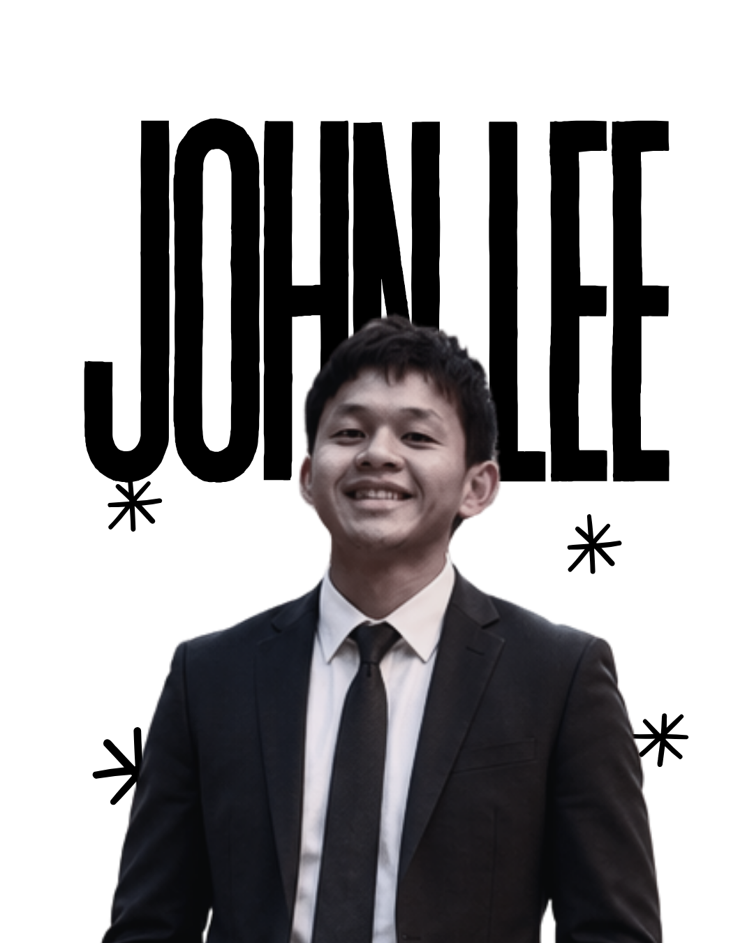 Young man in a black suit and tie smiling at the camera.