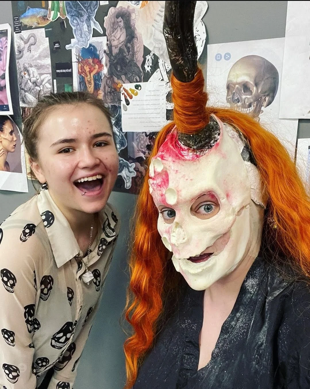 Model, Jamie, and Sam Moore Lake (makeup artist) smiling in the makeup chair while wearing a protective cape during a special effects application for a Loki character concept.