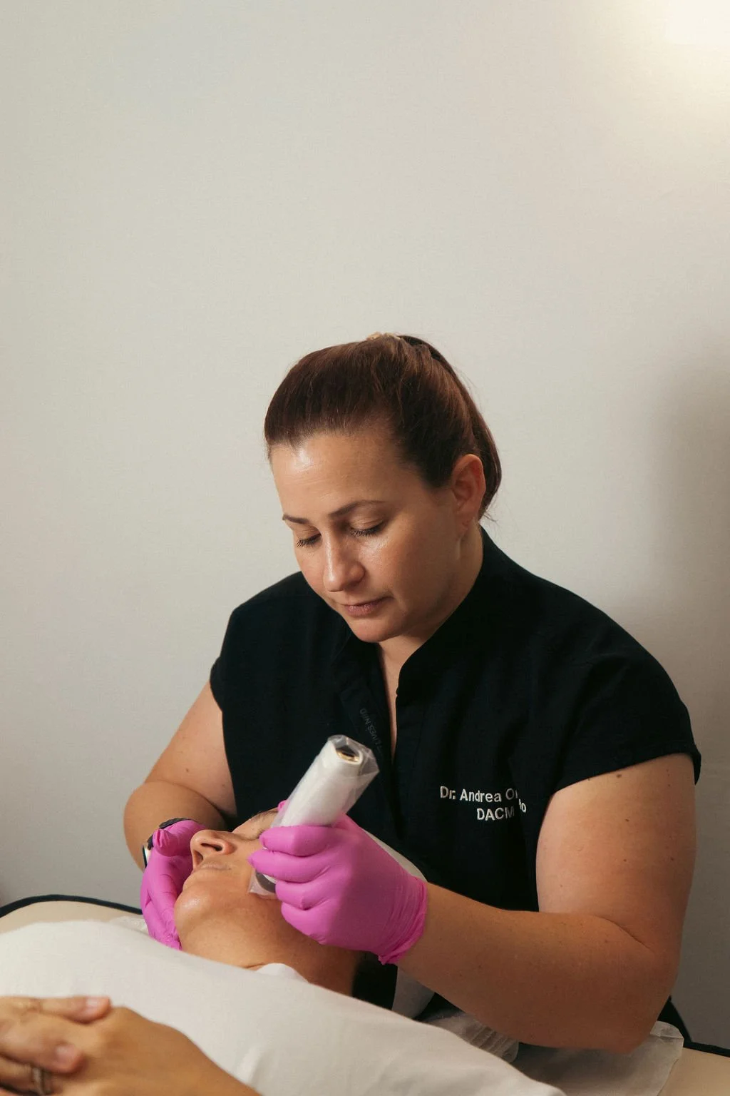 Dr. Andrea Orvieto performing cosmetic acupuncture in a calm treatment room