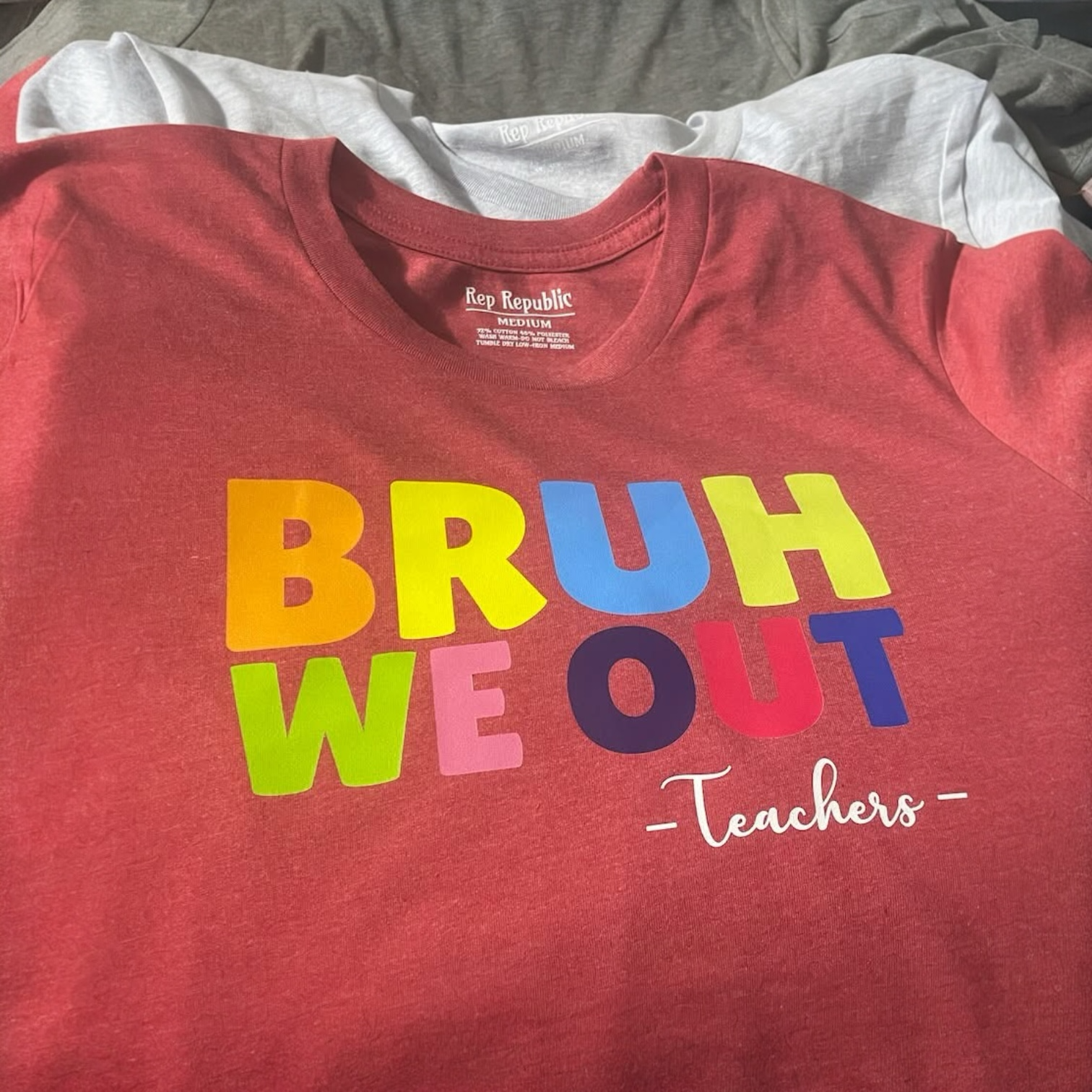 Red T-shirt with colorful text that reads 'BRUH WE OUT' and the word 'Teachers' in white cursive below.