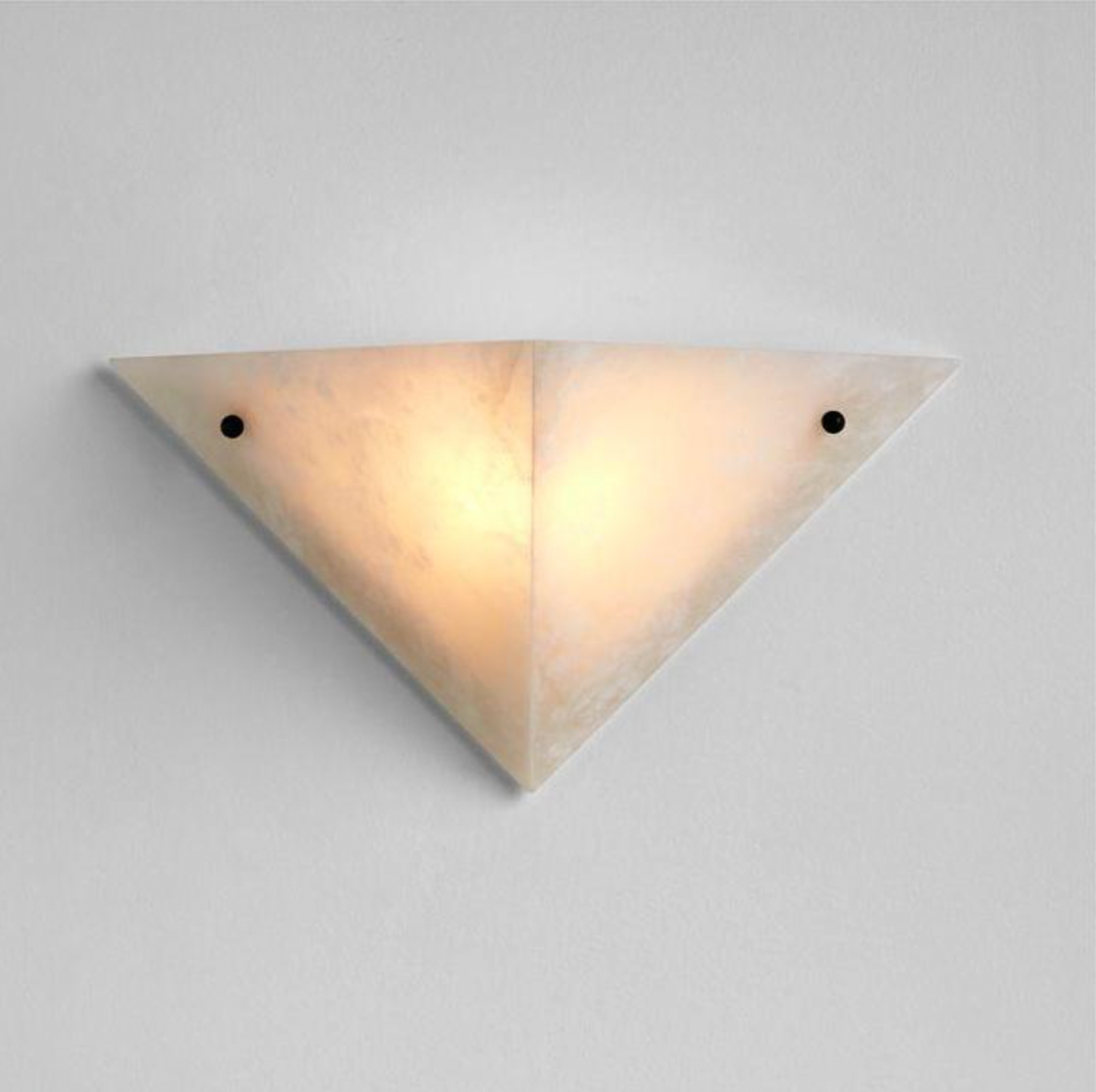 Wall light fixture with a triangular shape, off-white color, mounted on a white wall.