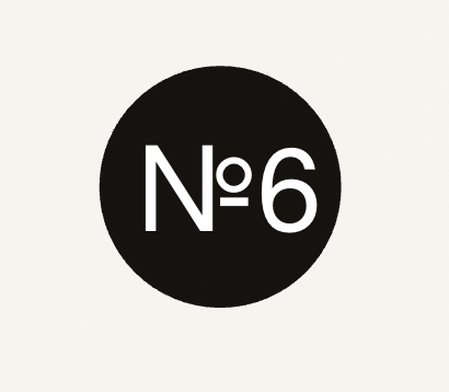 Black circle with white text reading "N°6" inside.