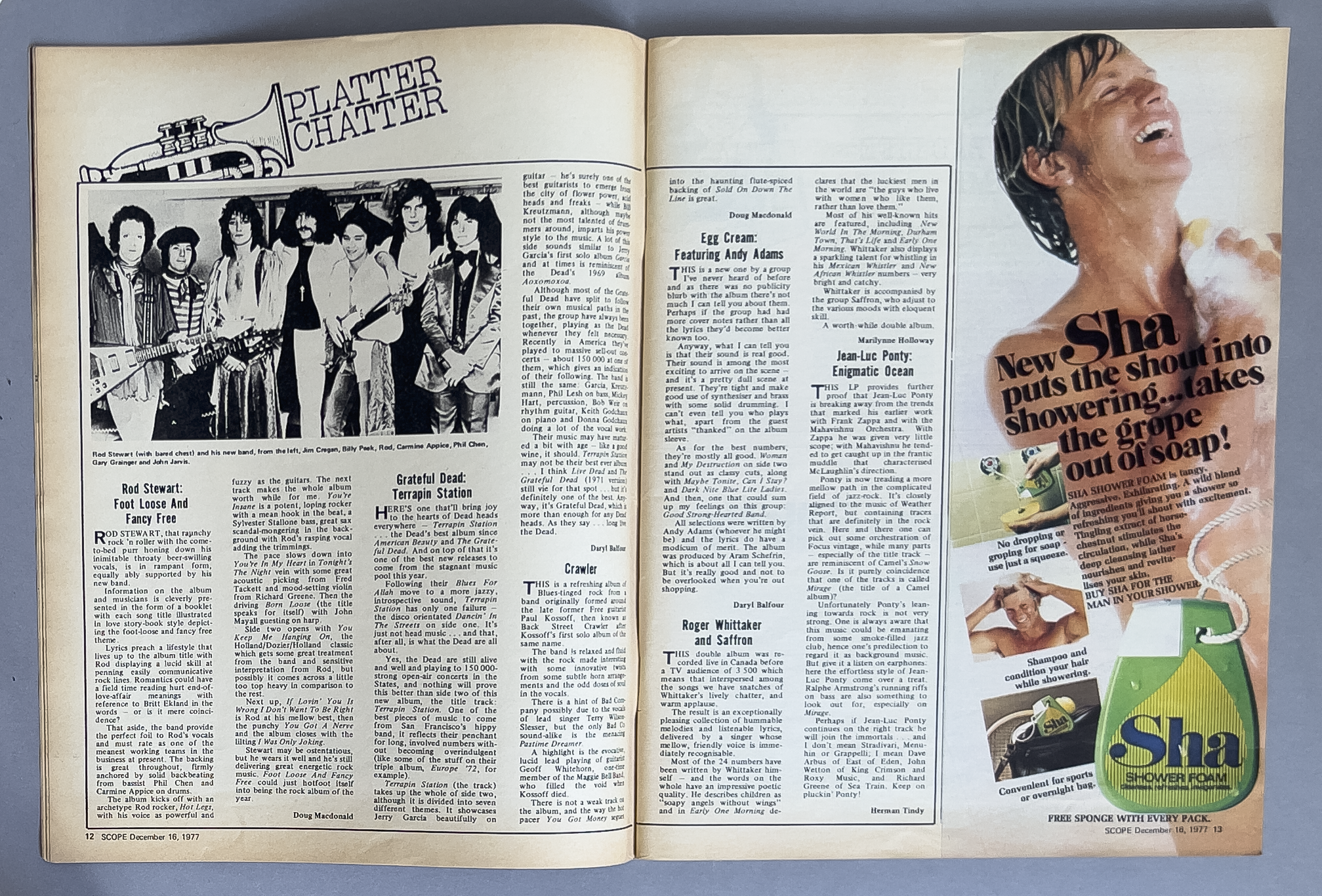 A two-page magazine spread featuring a black-and-white photo of a band and an article about them on the left, and an advertisement for Sha shower foam on the right with a woman showering and a large green bottle of shower foam.