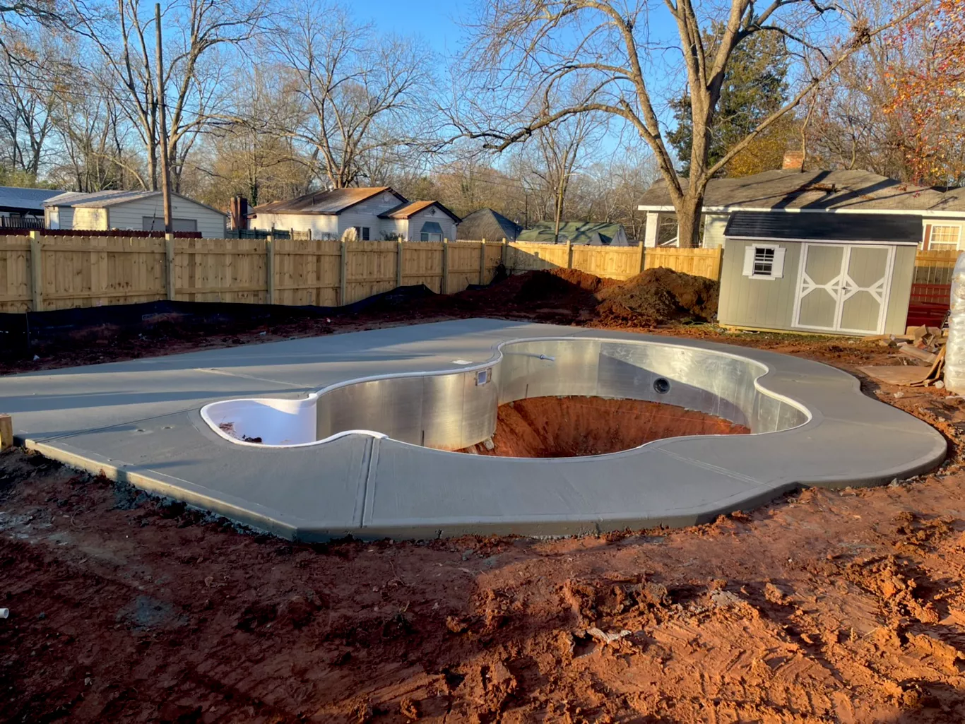 Custom poured concrete pool deck surround built perfectly to the contours of a backyard swimming pool in Atlanta.