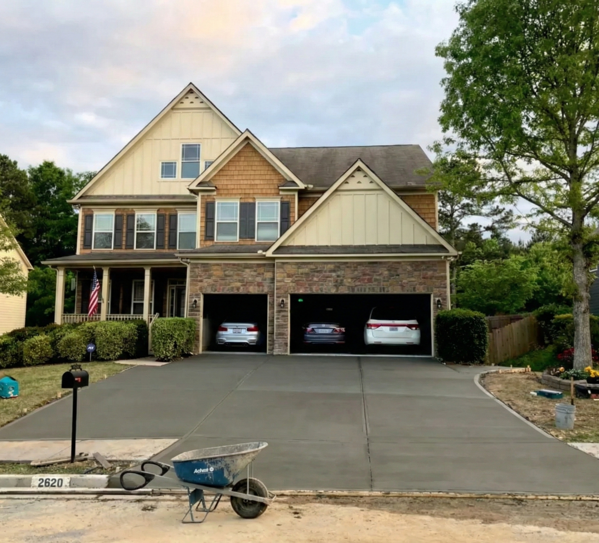 Newly finished large residential concrete driveway replacement in front of a multi-car garage home in Atlanta.