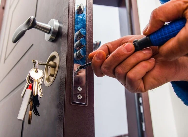 Commercial locksmith installing and servicing a secure door lock system