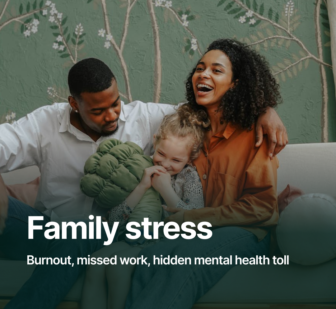 A family of three sitting together on a couch, smiling and laughing, with a green floral wallpaper background. The woman has curly hair, the man has short hair, and the young girl has light-colored hair.