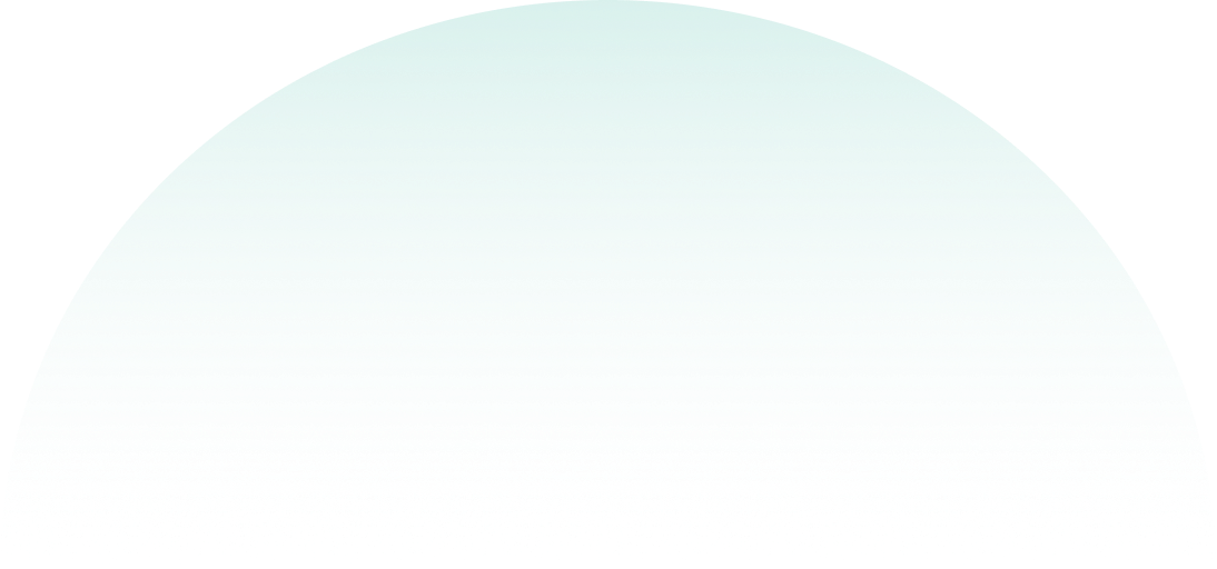 A person with light-colored hair and glasses holding a small puppy in their hands.