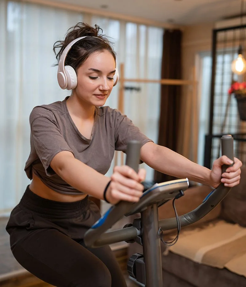 Patient on an exercise bike in the comfort of their home