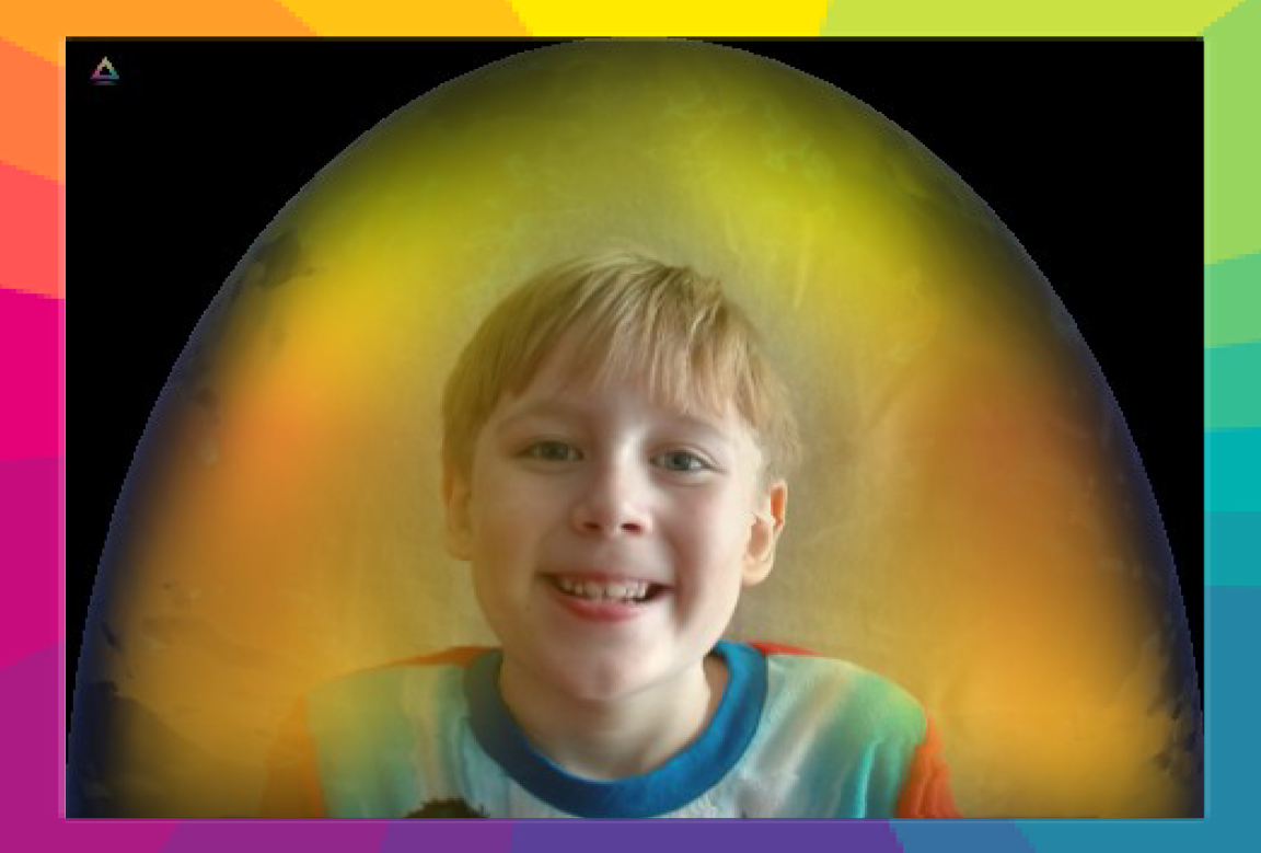 A young boy smiling at the camera, with colorful rainbow-like background representing his aura after getting a youth aura reading.
