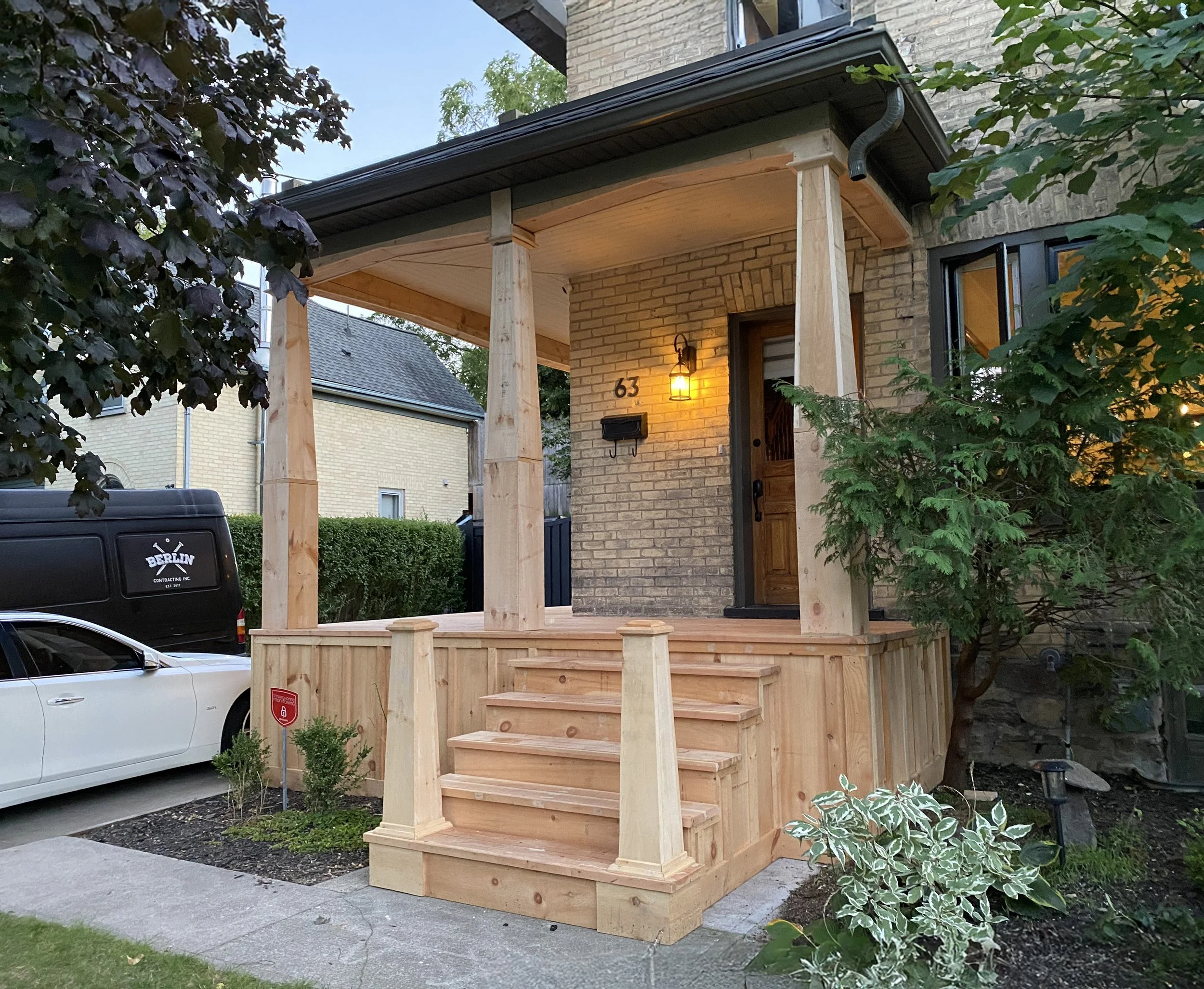 An exterior house shot of a fresh new porch that includes custom newel posts and columns.