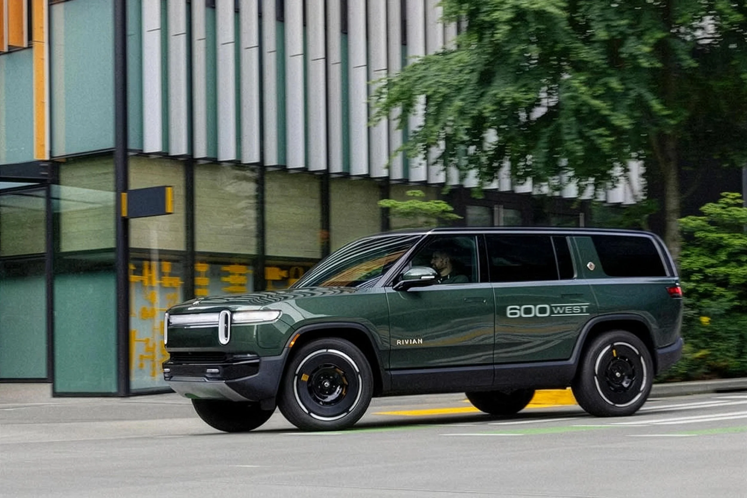 Second-generation-Rivian-R1S-left-front-three-quarter-view-turning-right-on-a-city-street-V3.jpg