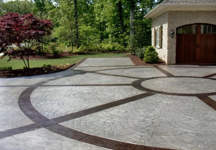 Sealed and stained decorative geometric paver driveway.