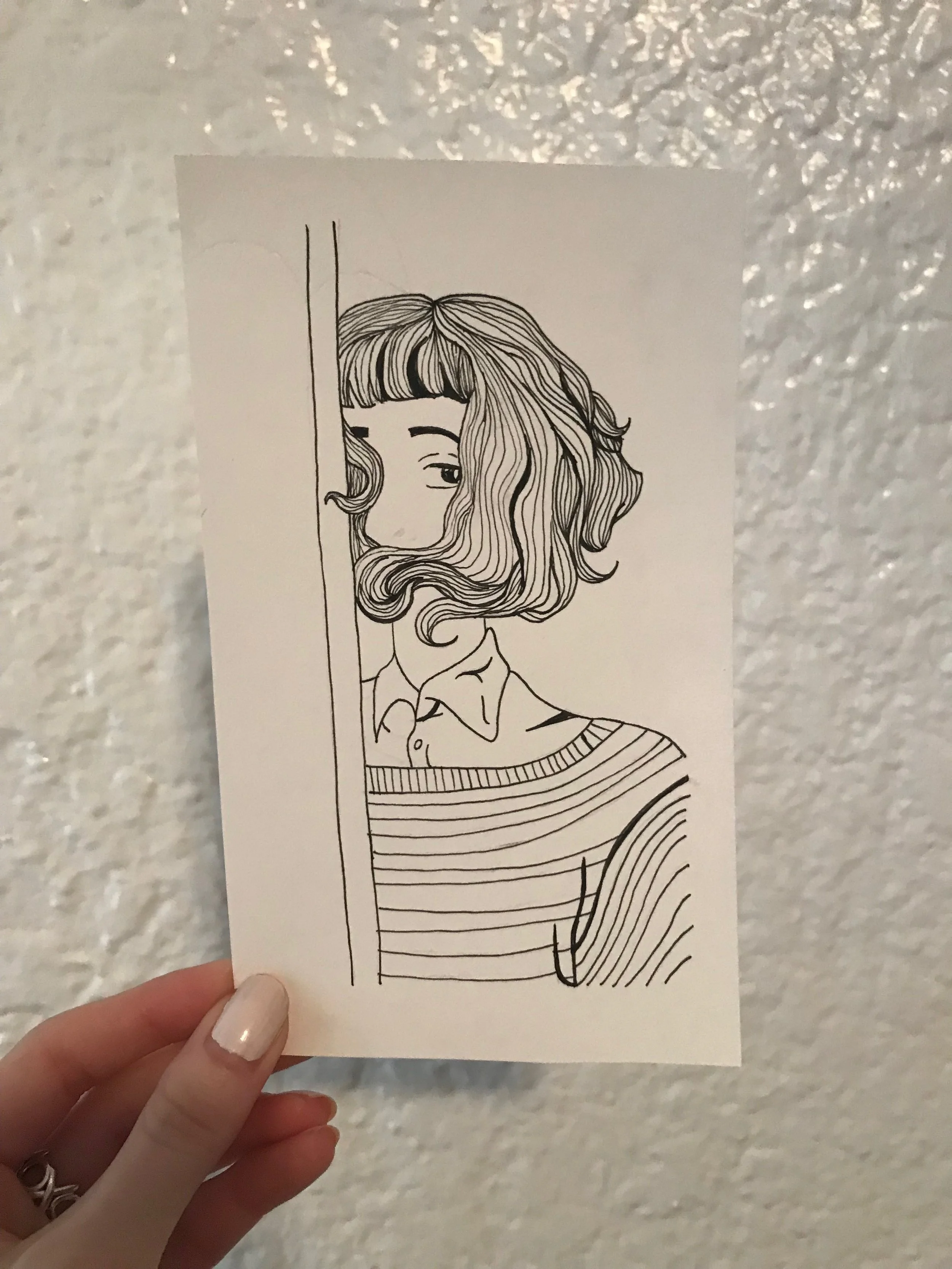 Line drawing of a girl with wavy hair, partially peeking from behind a vertical line, with a striped shirt, set against a textured wall background.