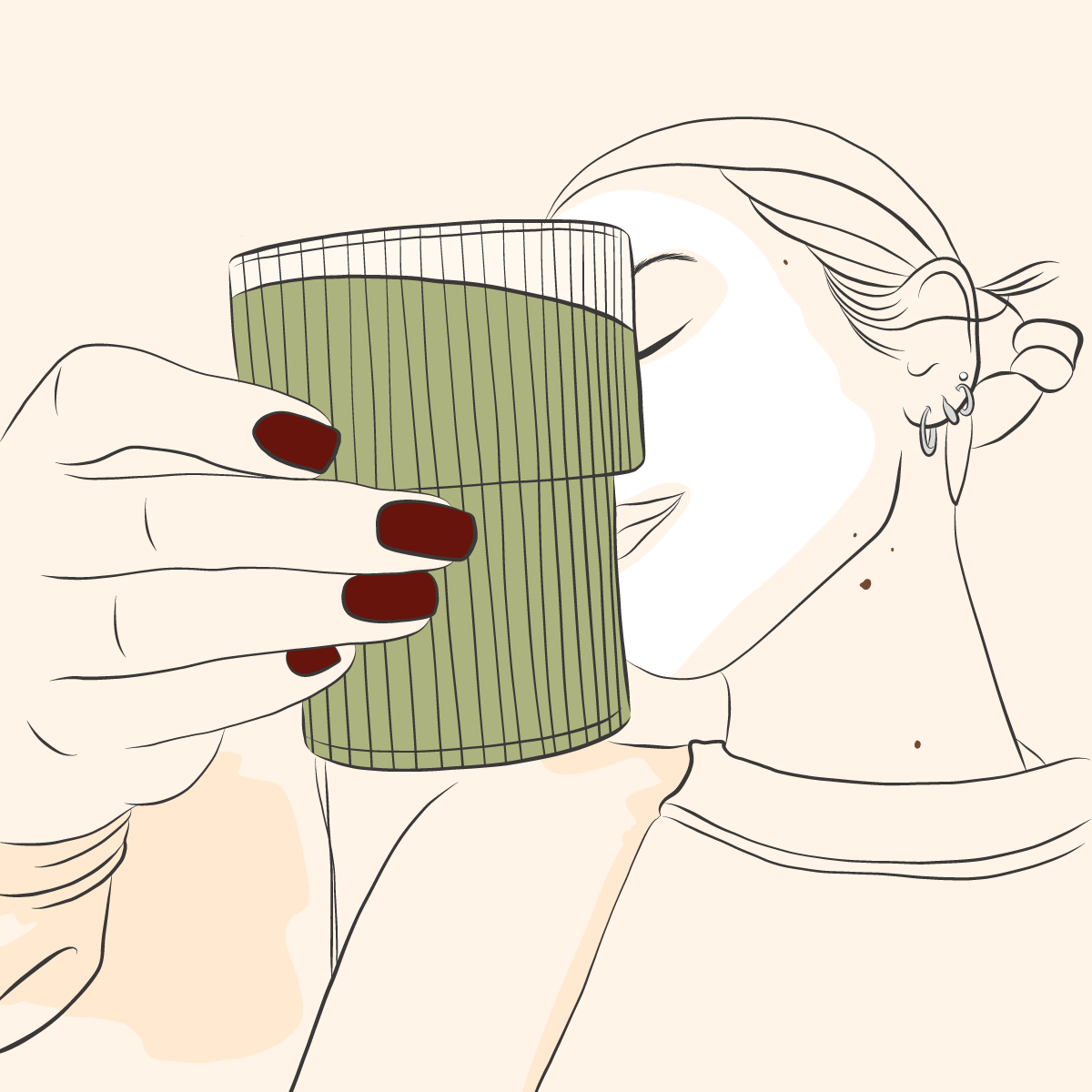 A woman with tattoos and piercings drinking from a tall, ribbed green glass.