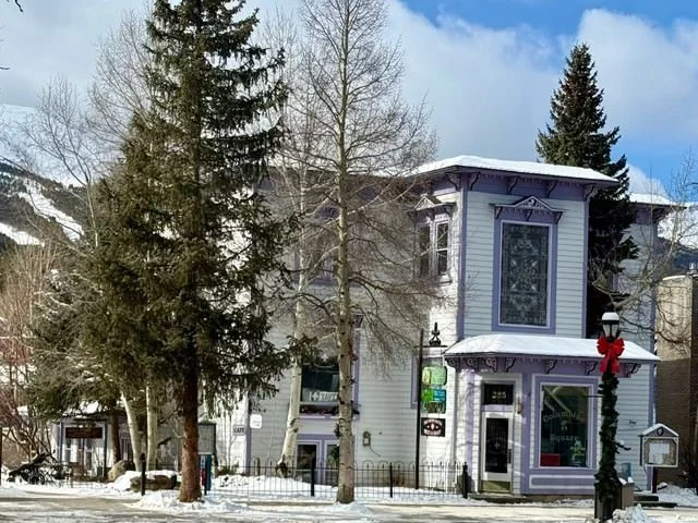 The Big Hands Kind Heart studio is located on the third floor, unit 3C, of a light purple Victorian-style building located on Main street in historic Breckenridge, CO.