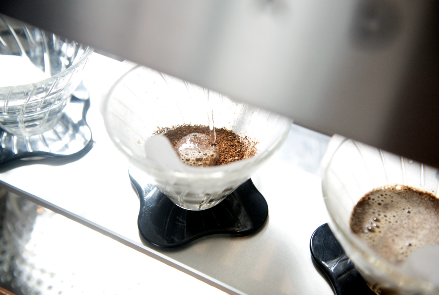 Pour-over coffee brewing with water and grounds