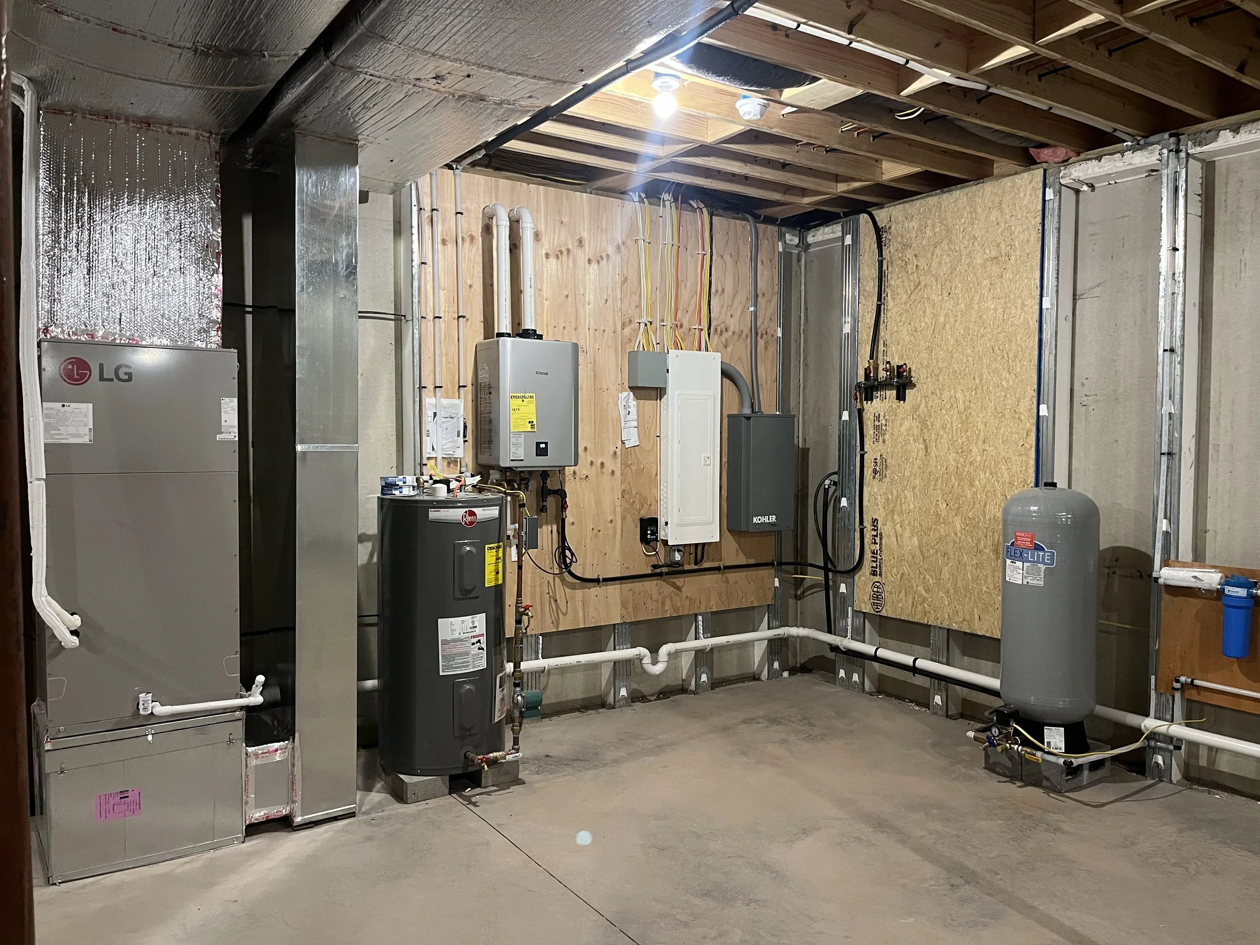 Residential mechanical room with HVAC system, water heater, and electrical infrastructure