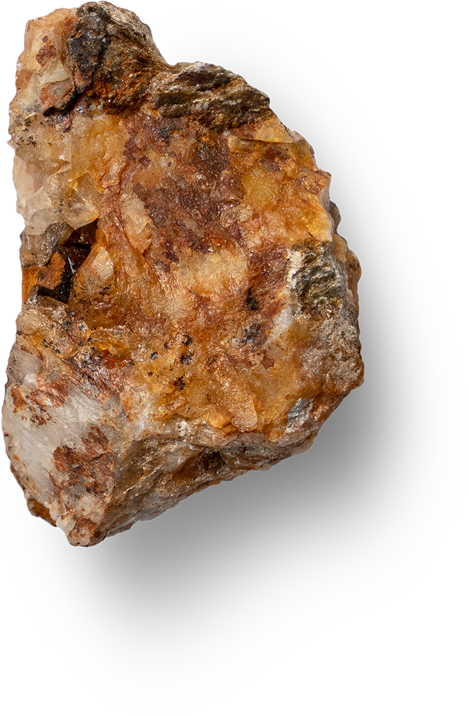 Close-up of a rough, multi-colored mineral or gemstone specimen with reddish, orange, brown, and white hues.