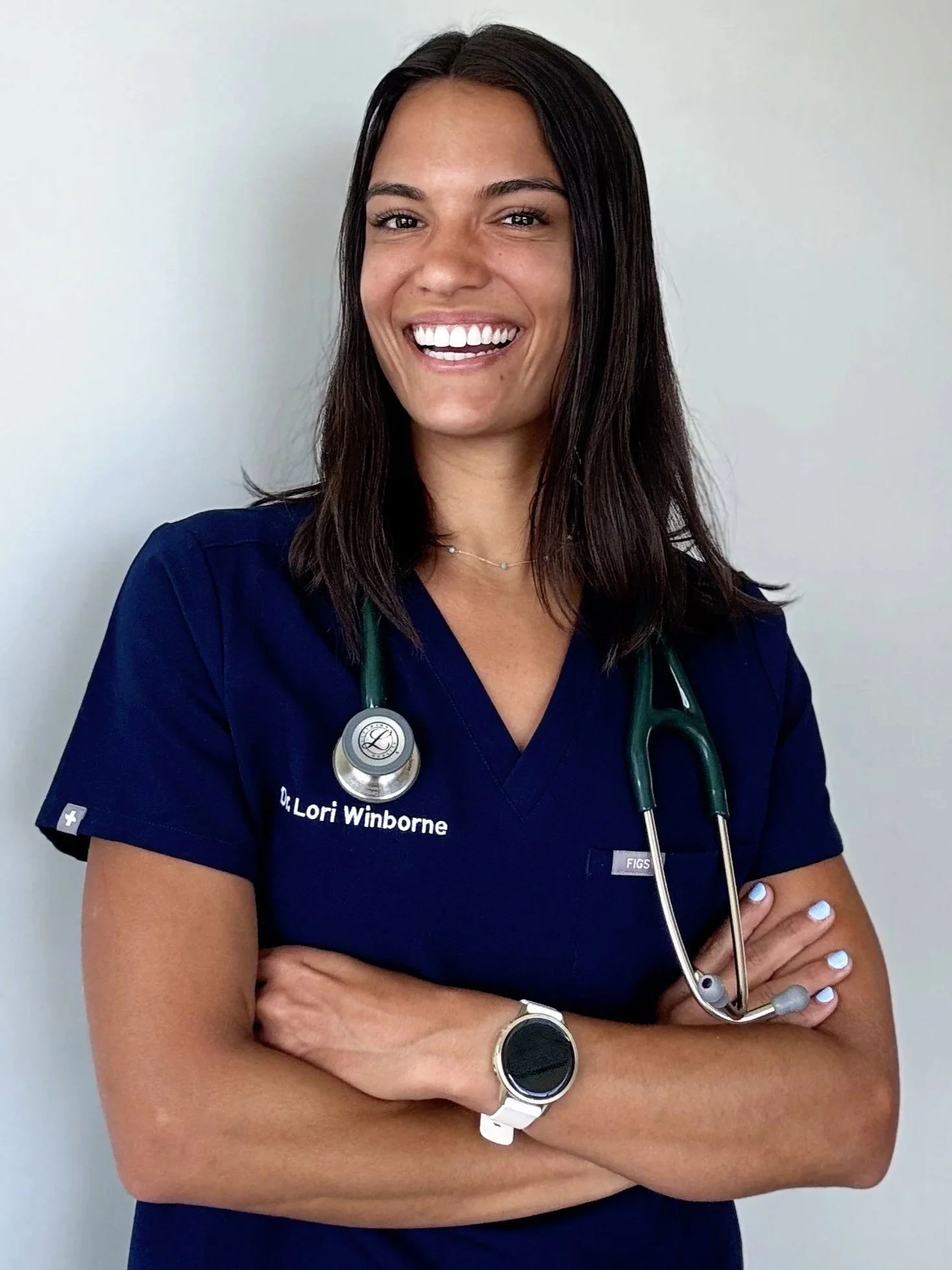 female veterinarian navy blue scrubs green stethoscope happy