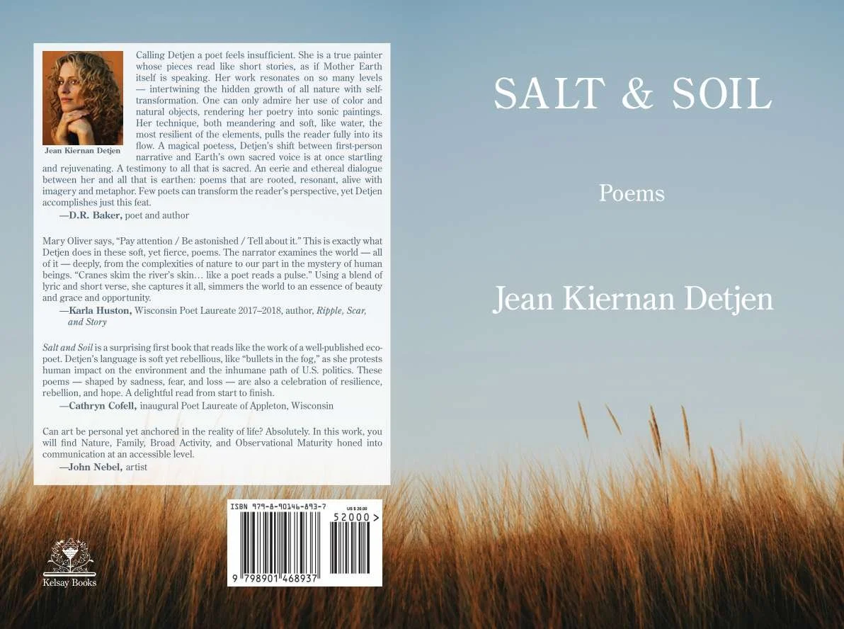 Full book cover jacket for "Salt & Soil: Poems" by Wisconsin eco-poet Jean Kiernan Detjen, published by Kelsay Books. Front features a nature photo of blue sky and marsh reeds; back features the author headshot, poetry book blurbs, and ISBN barcode.
