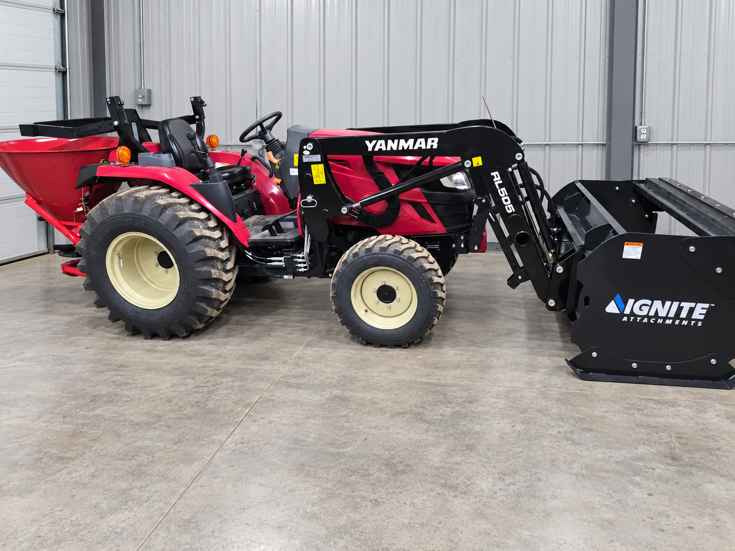 Newsome Solutions 40 HP tractor and front loader in a clean professional equipment bay.