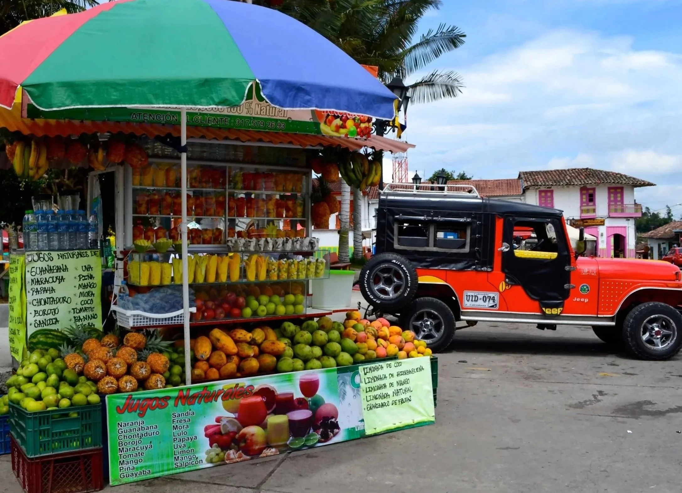 Colombia has many exotic fruits and it is fun to try them throughout a trip. This is a fruit stand and a taxi in Salento.