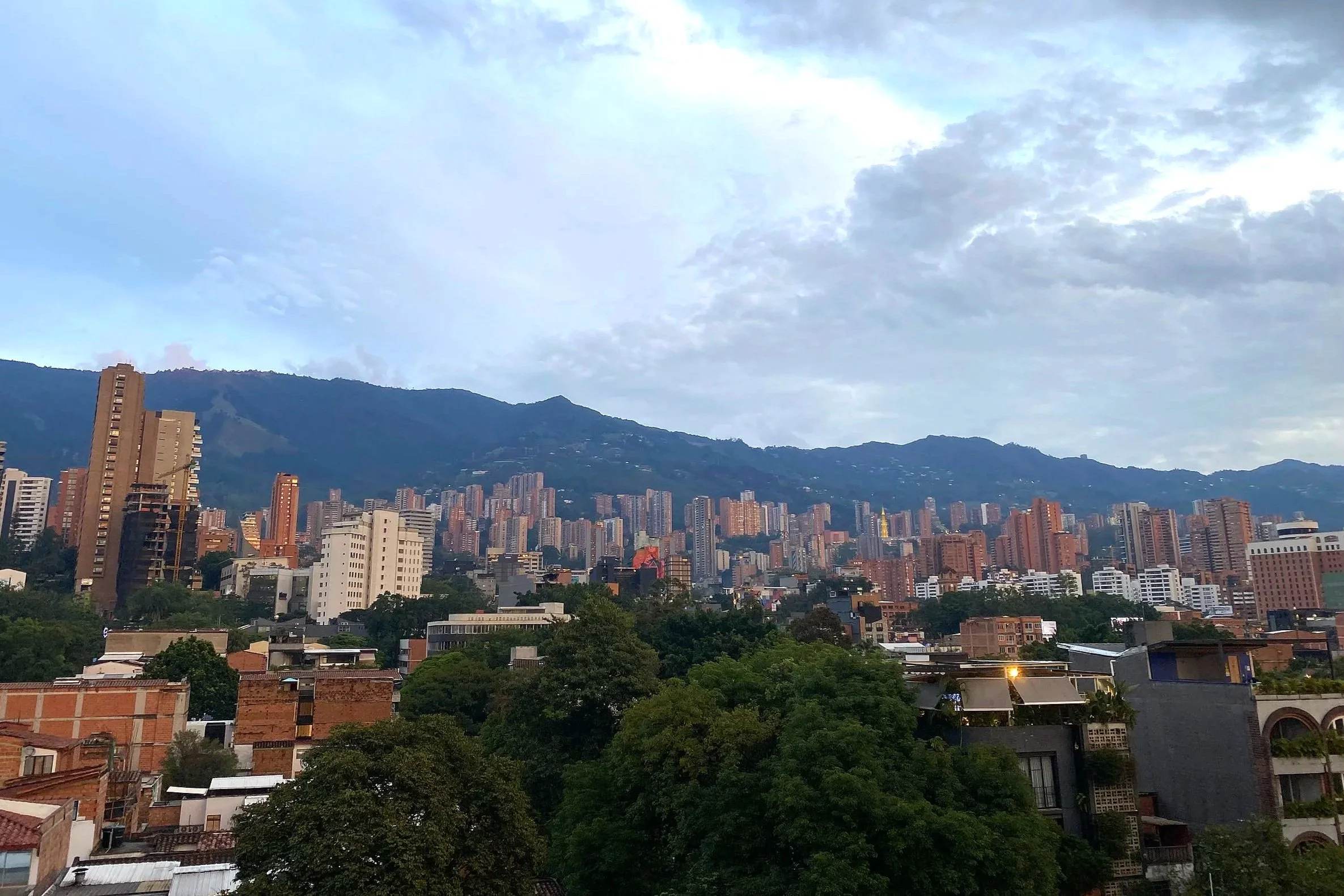 A cityscape of Medellín, Colombia, a vibrant city for traveling to as a starting point for a tour of or trip to Colombia, especially before visiting the coffee region.