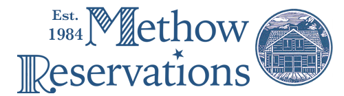 Logotype for Methodow Reservations featuring the text 'Est. 1984' and an illustration of a house with mountains in a circle.
